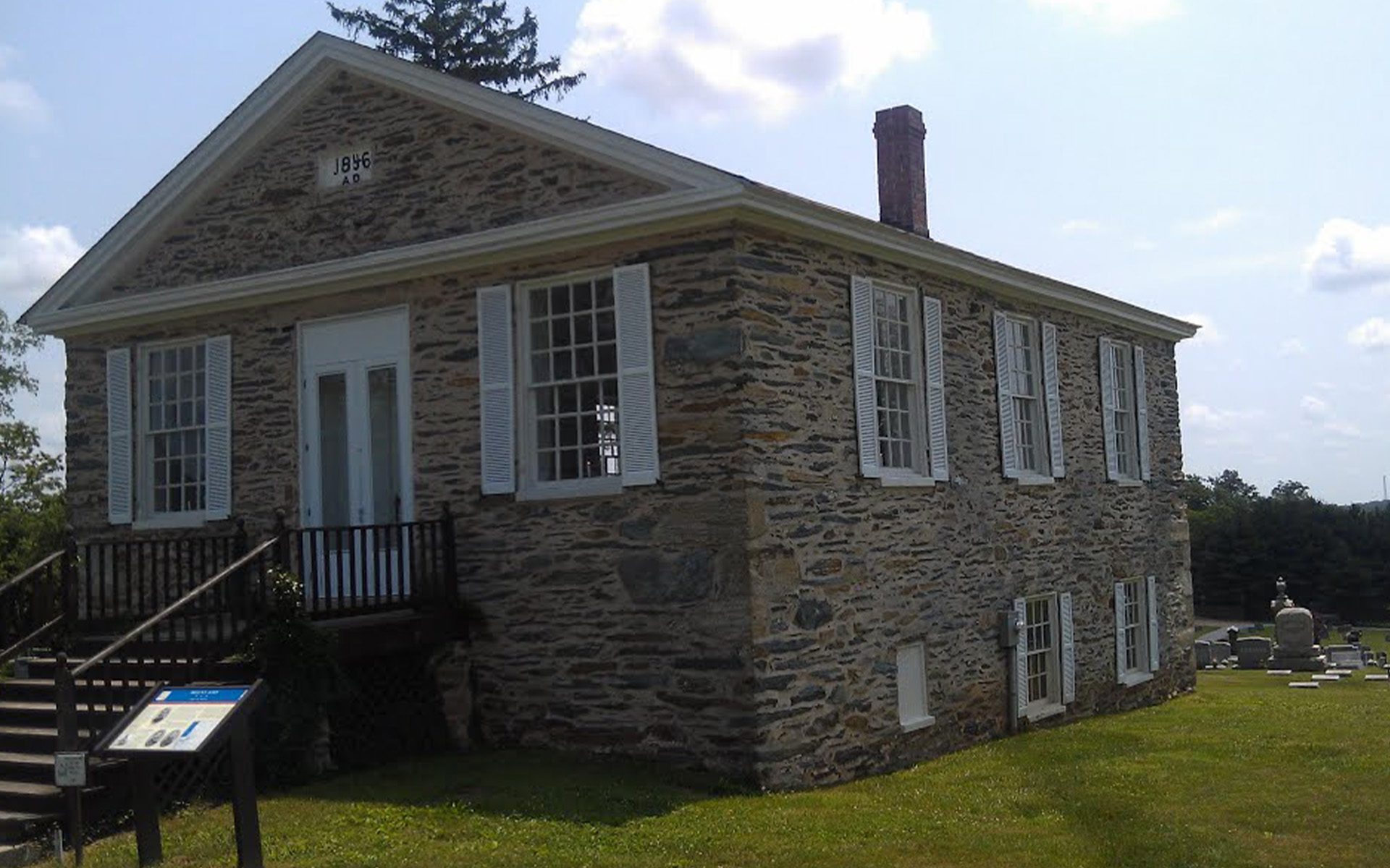 Homepage - Small Historical Building in Front of a Cemetary